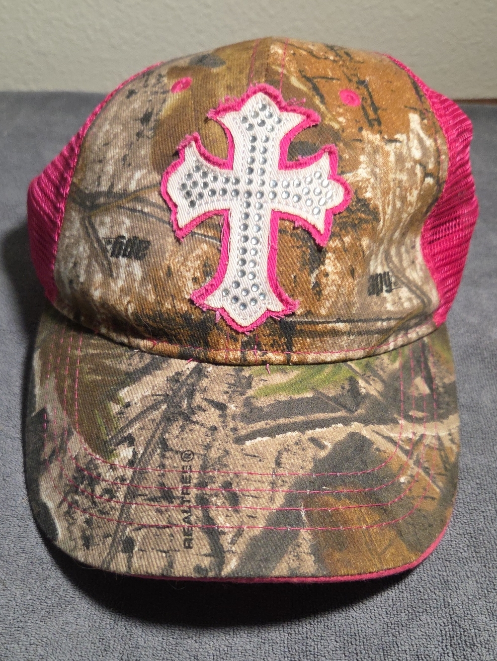 NFINITY New Camo Trucker Hat with Pink Cross Accent